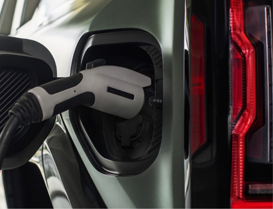 Close up of charging port with charger plugged in on a GMC Hummer EV SUV - Weirs Motor Sales in Arundel ME