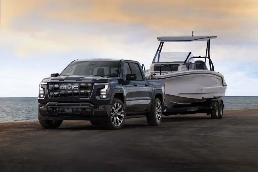 2027 GMC Sierra 1500 Denali Ultimate towing a boat near Portland, Maine at Weirs GMC