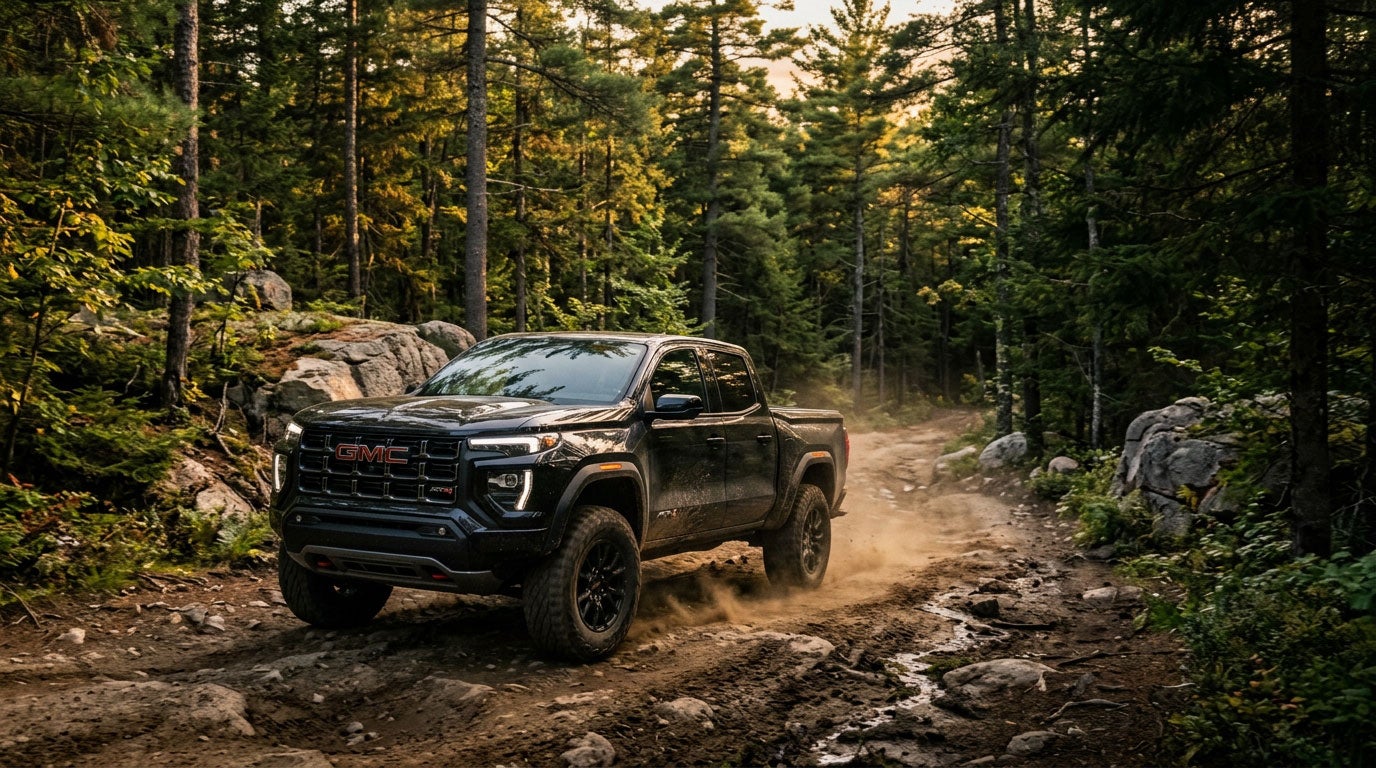 GMC Canyon AT4 on a dirt camp road in the Maine pine forest