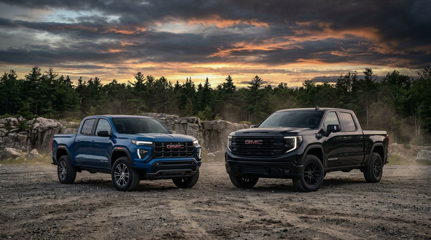 2026 GMC Canyon next to a GMC Sierra 1500 Double Cab in Southern Maine at golden hour