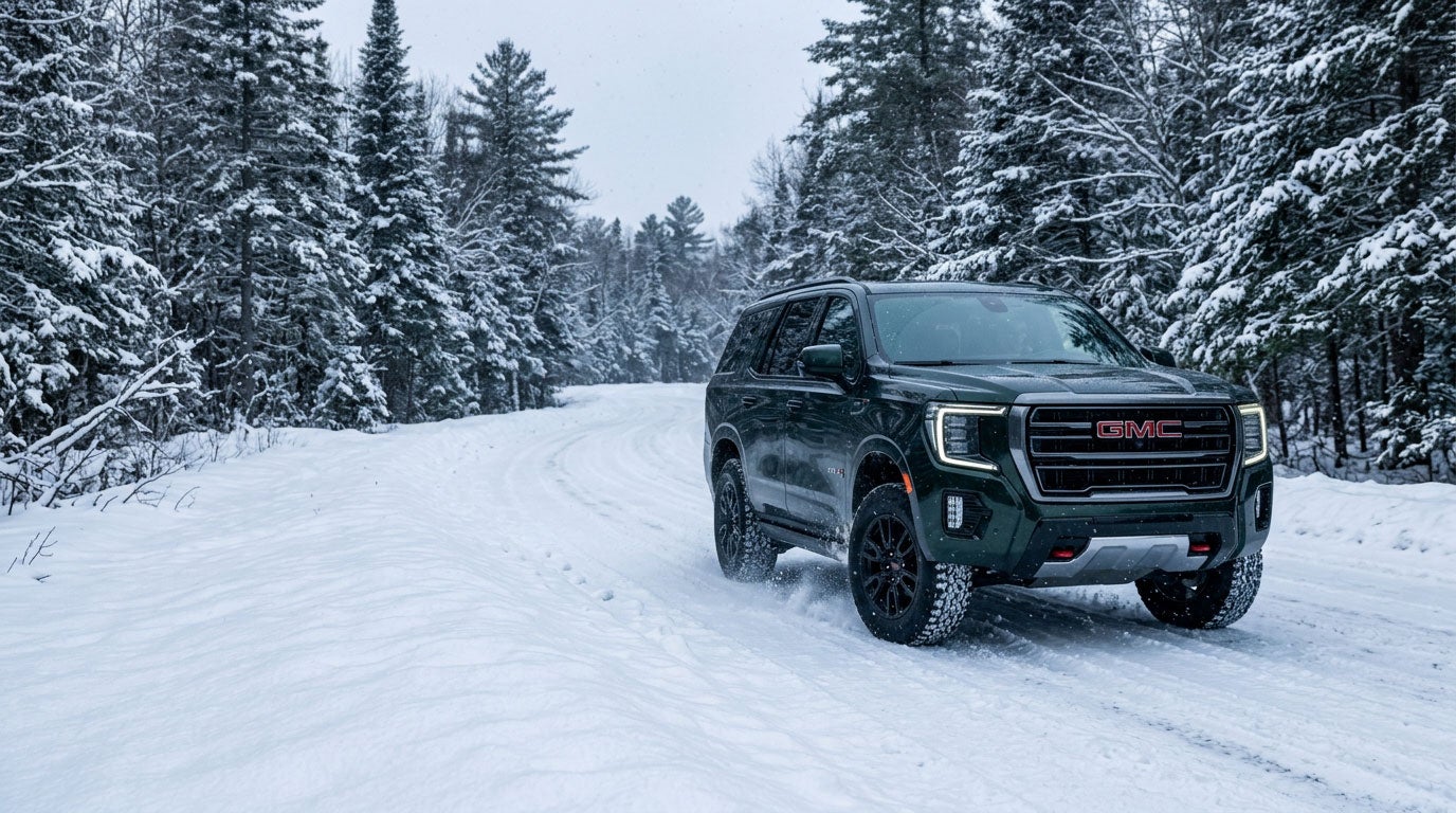 GMC Yukon AT4 on a snowy Maine forest road