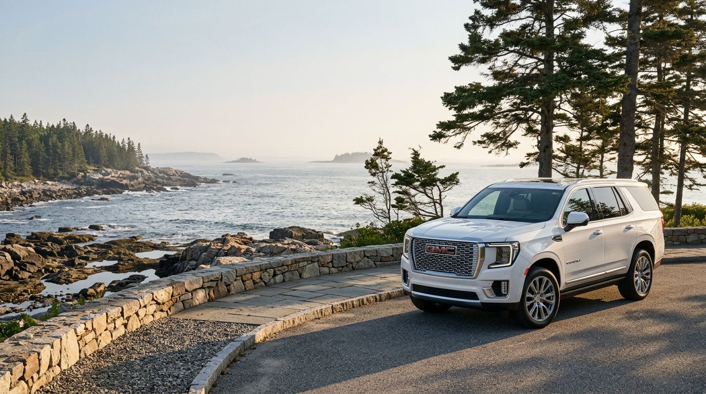 2026 GMC Yukon Denali on a Southern Maine coastal road at golden hour